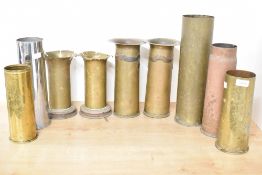 A group of nine British and German World War I brass and chrome trench art shell cases, three with