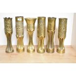 A group of six World War I French and American 75DEC brass trench art shell cases, five with