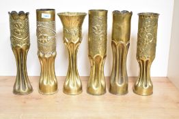A group of six World War I French and American 75DEC brass trench art shell cases, five with