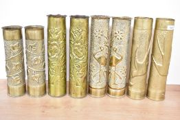 Four pairs of World War I French brass trench art shell cases, embossed and hand hammered with