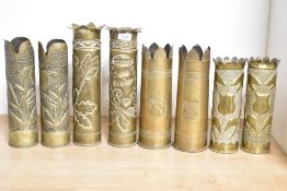 Four pairs of French and British brass World War I trench art shell cases, each with shaped