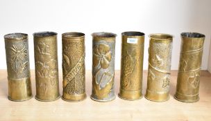 A group of seven pre and World War I French and German brass trench art shell cases, each embossed