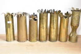 A Group of seven French and British brass World War I trench art shell cases, mainly 75DEC, each