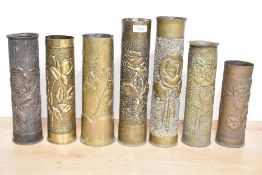 A group of seven World War I brass trench art shell cases, mainly French 75DEC, each embossed and