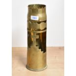 An interesting British World War I brass trench art shell case, with part lobed rim over a cut-out