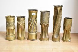A group of six French and British World War I brass trench art shell cases, each decorated with