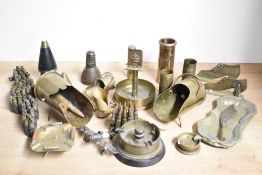 A selection of mixed World War I and II adapted brass trench art shell cases, ashtrays, scuttles,