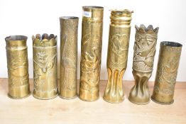 A group of seven British, German and French World war I & II brass trench art shell cases, each