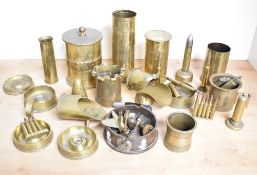 A selection of adapted World War I brass trench art shell cases, ashtrays, vases, chamber sticks,
