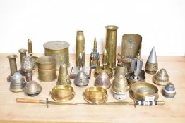A selection of adapted World War I brass trench art shell cases, ashtrays, vases, candlesticks,