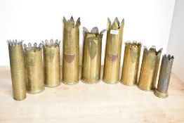 Two pairs of British and German World War I brass trench art shell cases, each with shaped