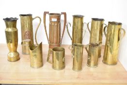 A group of British and French World War I trench art shell cases, re-purposed and jugs and handled