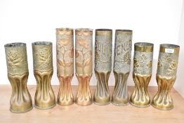 Four pairs of World War I British and French brass trench art shell cases, embossed and hand