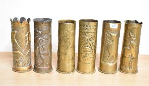 A group of six German World War I brass trench art shell cases, each embossed and hand hammered with