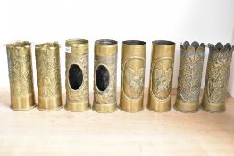 Four pairs of German brass world War I trench art shell cases, each embossed and hand-hammered