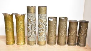 Four pairs of French and German brass World War I trench art shell cases, each with embossed foliate