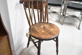 A Victorian kitchen chair having solid seat and spindle back