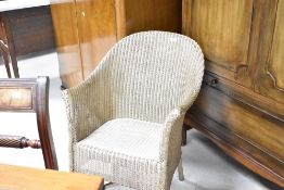 A vintage Lloyd Loom tub chair, in gold finish