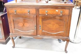 An early 20th century mahogany sideboard, having a raised and shaped back over the moulded