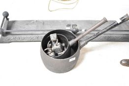 A selection of cast iron pans, weights and small fender