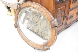 A late 19th or early 20th Century oak oval wall mirror, approx. 65 x 90cm