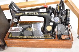 A Singer sewing machine having integral case and hand crank mechanism