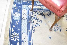 A vintage carpet square having cream and blue ground, approx. 274 x 200cm