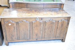 A period oak kist having panelled decoration and lift lid, dimensions approx. W136 D51 H65cm