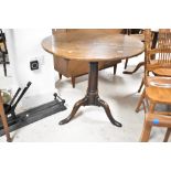 A 19th Century oak pedestal table having circular top, turned column and triple splay legs, having
