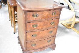 A reproduction walnut dwarf chest of four long serpentine fronted drawers, width approx. 51cm