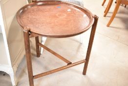 A vintage oak and ply occasional tray table having circular top and folding tri-frame , diameter
