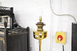An antique brass standard lamp, converted from oil to electric, having Corinthian column on
