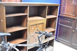 A late 19th or early 20th Century stained frame bookshelf having central cupboard, dimensions