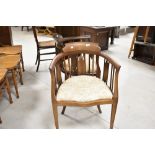 A pair of Edwardian mahogany bedroom armchairs having later upholstery, on square tapered legs and