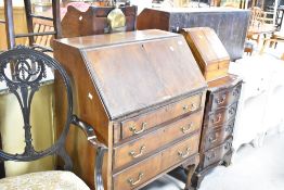 A mid 20th century mahogany bureau having typical drop flap section, with stationery fitted