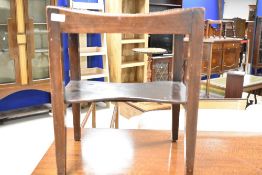 An Arts and Crafts stool, having lattice work leather top and shaped undertier, labelled for G E