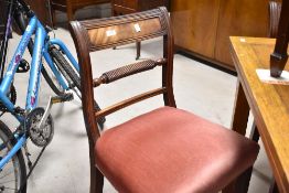 A set of four 19th century rail back dining chairs in the Regency style , having twist turn back