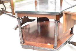 A modern mahogany octagonal coffee table and CD rack