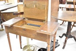 An interesting early 20th Century oak metamorphic writing table, having fold out compartmented