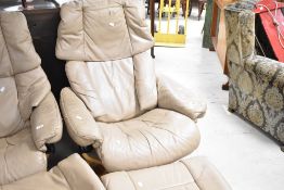 A Stressless recliner armchair and footstool in cream leather on light beech frame