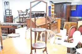 An Edwardian mahogany folding cake stand, having three circular tiers, with line inlay decoration,