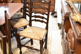 A set of six traditional rush seated ladder back kitchen dining chairs