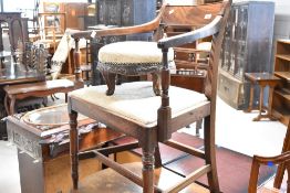 A reproduction Regency carver chair and a circular upholstered footstool