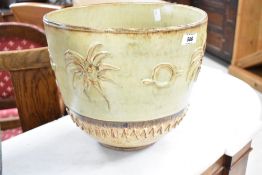 A vintage jardiniere , height approx 27cm, having green and cream glaze with palm decoration