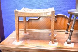 An Arts & Crafts oak and leather lattice work stool in the Arthur Simpson Handicrafts style ,