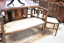 An Edwardian mahogany salon suite comprising settee and three chairs, all with line inlay decoration