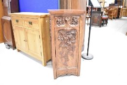 An Arts & Crafts oak coal purdonium having frieze drawer and drop front, with stunning carved ivy