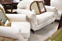 A modern three piece lounge suite in off white with subtle foliate design (marks to back of one