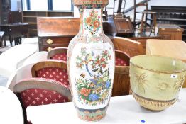 A vintage decorative porcelain floor vase, having vibrant foliate and bird design in the Cantonese