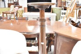 An early 20th Century mahogany jardiniere stand having turned column with carved wheat design and